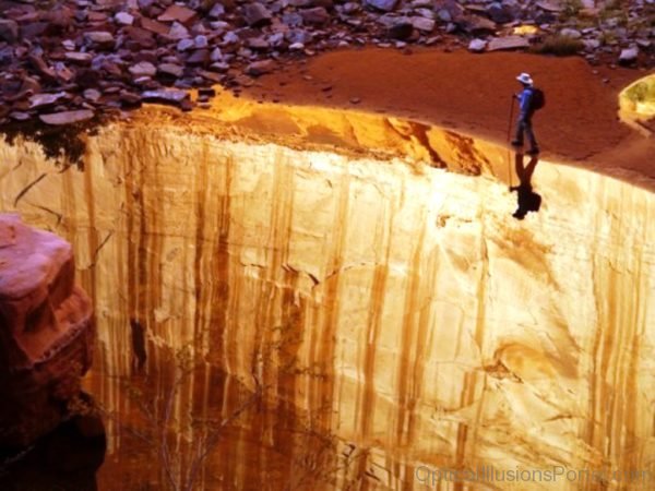 Shadow Illusion Falling Over A Cliff